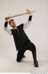 KEETA KNEELING POSE WITH SWORD